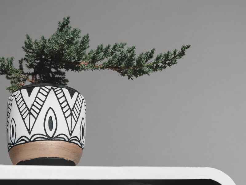 A black and white hand painted clay plant pot